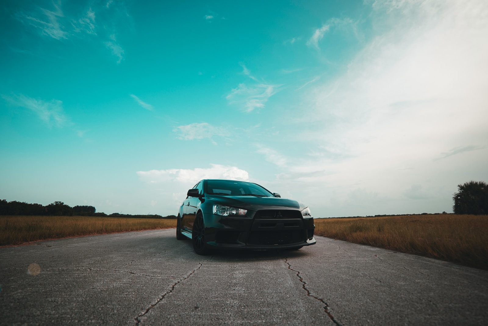 black vehicle on gray concrete road