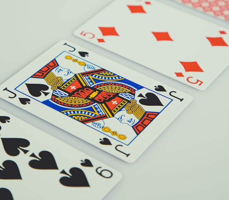 assorted playing cards on white surface