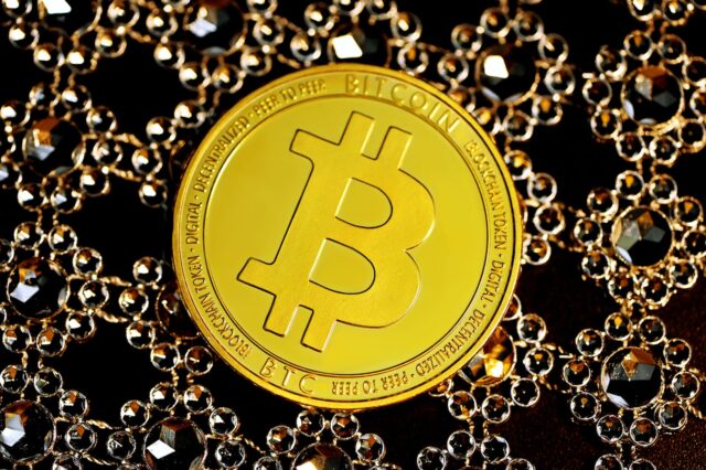 gold round coin on black beads