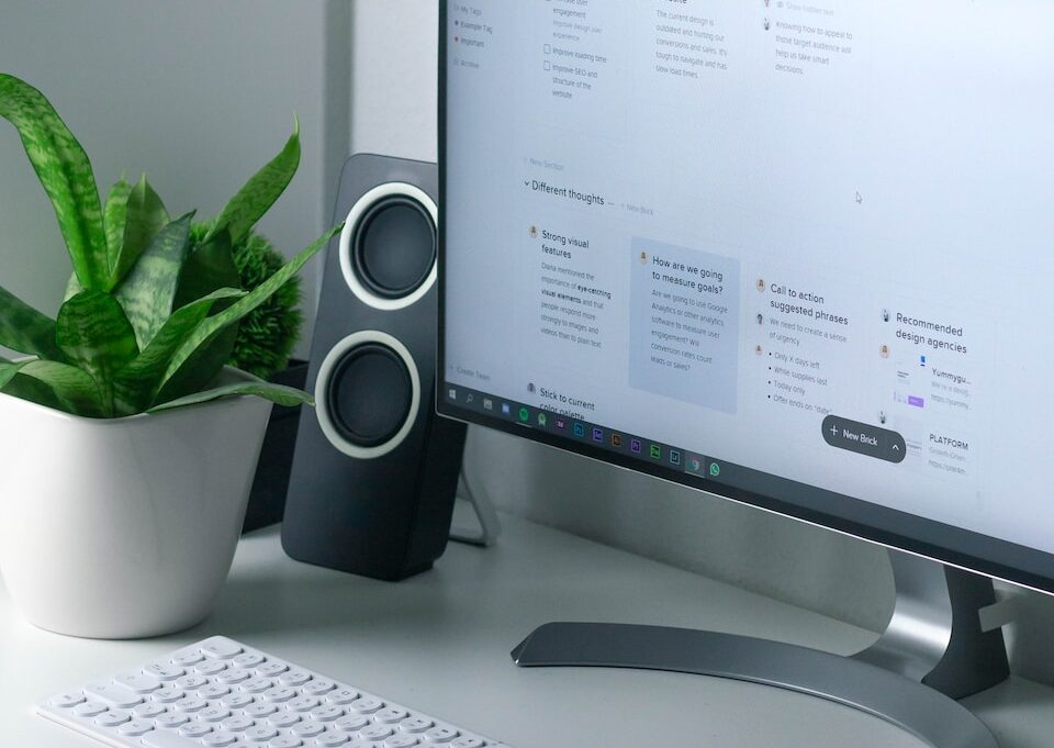 white computer monitor and white keyboard