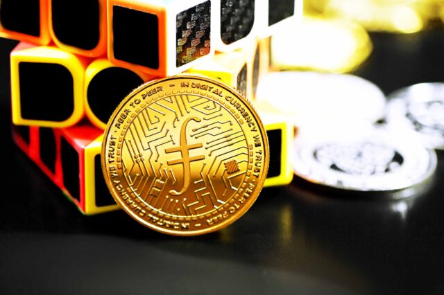 a bit coin sitting on top of a pile of cubes