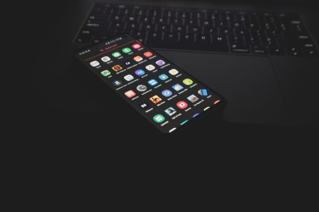 black iphone 5 on black computer keyboard