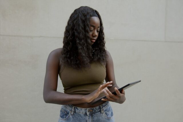 Female typing on her Surface laptop, with a blank wall in the background