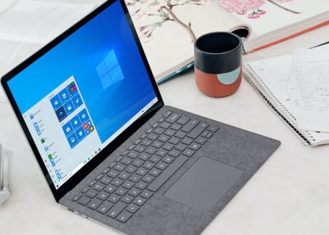 gray microsoft surface laptop computer on white table