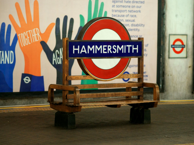 A bench with a sign on it Description automatically generated