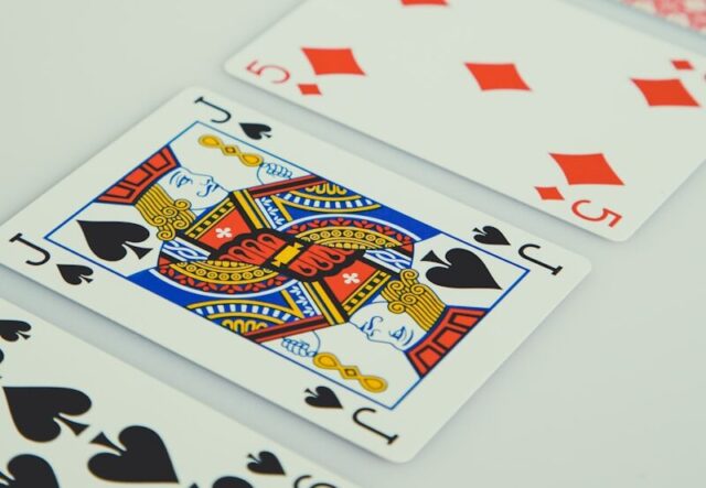 assorted playing cards on white surface